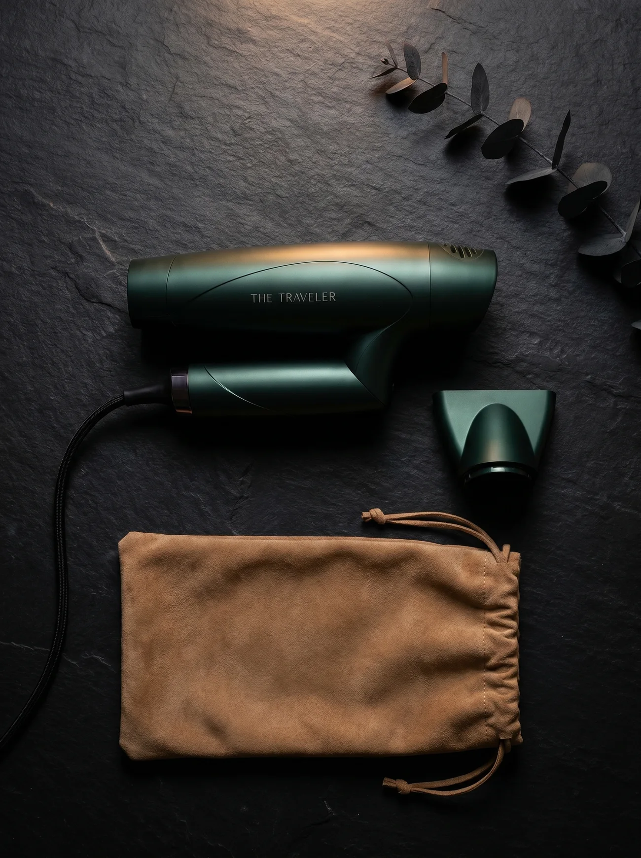 The Traveler kit on dark slate: folded dryer, magnetic nozzle, and storage pouch